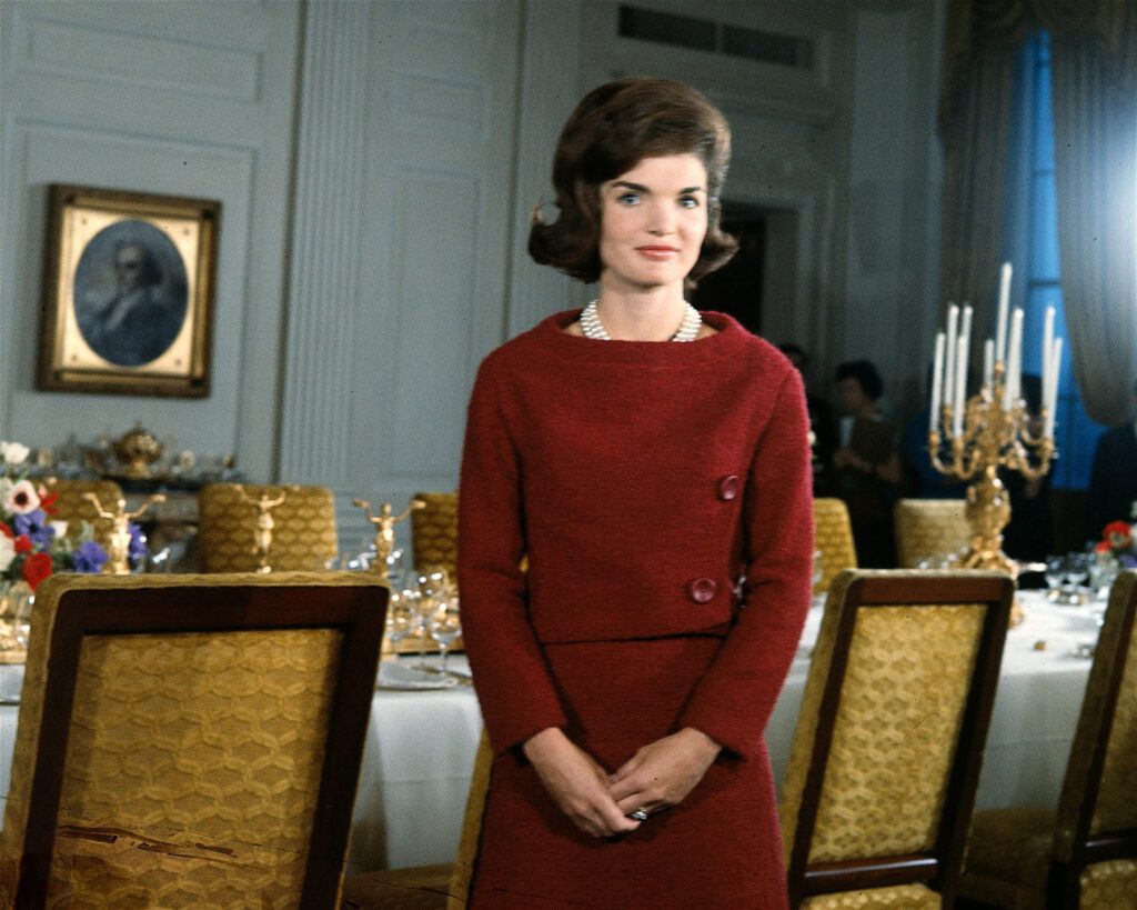 American First Lady Jacqueline Kennedy stands before a dining room table in the White House during the filming of a CBS News Special program called 'A Tour of the White House with Mrs. John F. Kennedy,' Washington DC, January 15, 1962.